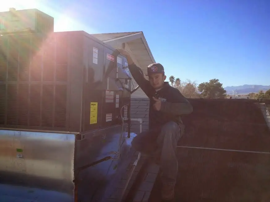 HVAC technician performing HVAC Inspection on a rooftop unit in Bedminster